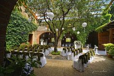 an outdoor wedding venue with white and green decorations