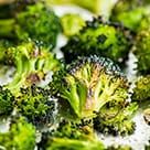 broccoli florets are being cooked in a pan