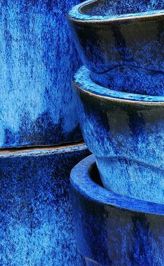 several blue bowls stacked on top of each other