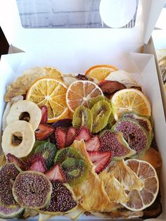 a box filled with sliced fruit on top of a table