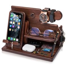 an iphone and glasses are in a wooden case with other items on the shelf next to it