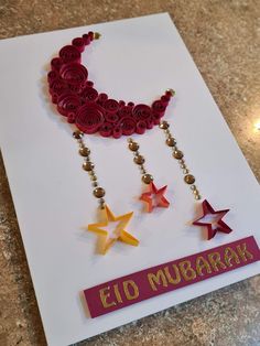 a card with paper stars and beads on it