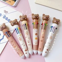 four pens with teddy bears on them sitting next to each other