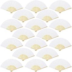 white paper fans with gold trims are arranged in a row on a white background