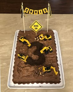 a birthday cake with construction trucks on it