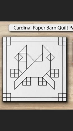 the cardinal paper barn quilt pattern is shown on top of a wooden table with scissors