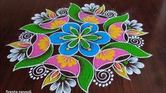 a colorful flower design on a wooden floor