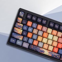 a computer keyboard with colorful keys sitting on top of it's backlit display