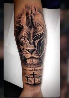 a man's arm with a black and grey tattoo on it, depicting the face of a lion