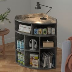 a round shelf with books and other items on it next to a couch in a living room