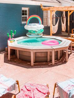 an inflatable hot tub with a rainbow ring on the top is surrounded by hammocks and chairs