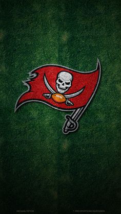 the tampa football team logo is shown on green grass with a skull and crossbones