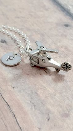 "This listing is for a hand stamped initial necklace featuring a 4/5\" x 3/5\" pewter helicopter charm & 3/10\" stainless steel initial pendant. The silver plated chain is 18\" long, but can be made to your desired length- see last photo in listing. Please indicate the chain length you would like in the 'notes to seller' section at checkout. All items are lead & nickel free. Message me with any questions, thank you! Add an initial to any necklace https://www.etsy.com/listing/170461597/ad Military Necklace, Military Jewelry, Poppy Necklace, Nature Necklace, Birthstone Charms, Initial Pendant, Nature Jewelry, Stainless Steel Necklace, Flower Jewellery