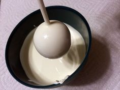 an egg in a bowl with yogurt and a spoon sticking out of it