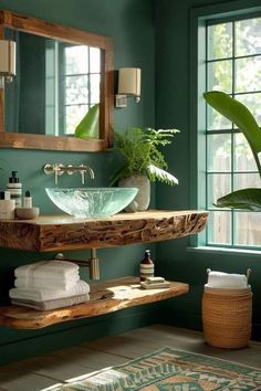 a bathroom with green walls and a wooden counter top, mirror above the bowl sink