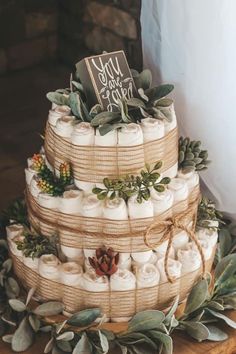 a three tiered cake made out of burlocks and wrapped in twine