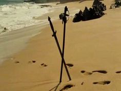 footprints in the sand near an ocean shore