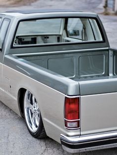 the back end of a silver truck parked in a parking lot