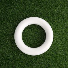 a white ring sitting on top of green grass