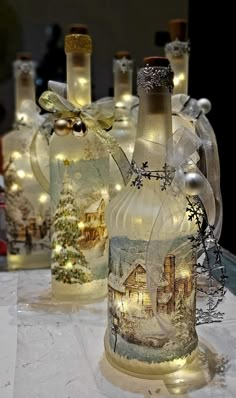 some bottles are sitting on a table with lights in them and decorations around the bottle