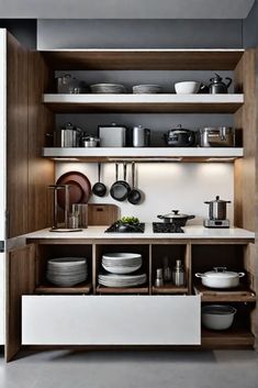 a kitchen with open shelves filled with dishes and pans