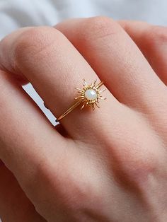 Gold Sunburst Adjustable Wire Wrapped Ring This dainty crystal beaded sunburst ring is handmade and perfect to be adjusted to any size. Thrive in your celestial core vibes or give this sweet sunshine ring as a gift to someone special! It looks amazing on its own of part of a set! ✨ DETAILS ✨ * 18 mm in diameter, adjustable * Material: white crystal bead, gold color wire If you have any questions, send me a message! 🌼 Dainty Wire Rings, Handmade Dainty White Crystal Ring, Handmade Adjustable Gold Birthstone Ring, Dainty Handmade White Crystal Ring, Handmade Celestial Style Jewelry Ring, Handmade Celestial Style Promise Ring, Dainty Handmade Gold Crystal Ring, Handmade Celestial Crystal Ring For Promise, Handmade Celestial Crystal Promise Ring