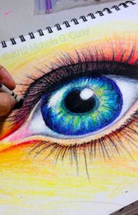 someone is drawing an eye with colored pencils