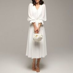 a woman in a white dress holding a bouquet