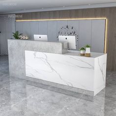 a white marble reception desk in a modern office building with two computers on the counter