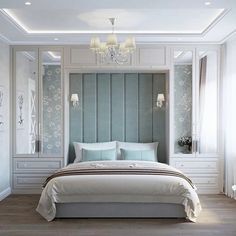 a bedroom with a bed, dressers and chandelier in the middle of it