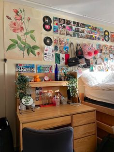 a bedroom with a bed, desk and various pictures on the wall above it's headboard