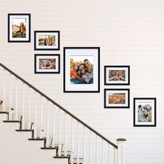 a staircase with pictures on the wall next to it