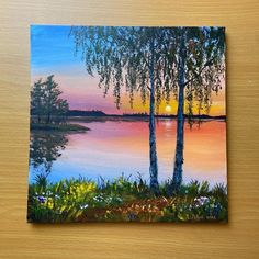 a painting of two trees in front of a lake with the sun setting behind them