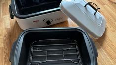 two black and white ovens sitting on top of a wooden floor next to each other