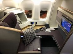 the inside of an airplane with two seats and a flat screen tv on one side