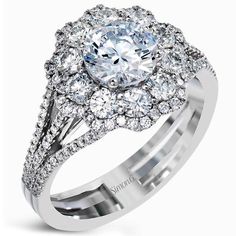 a white gold ring with an oval cut diamond surrounded by round diamonds