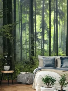 a bed room with a neatly made bed next to a forest wallpapered mural