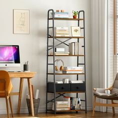 a desk with a computer on top of it next to a chair and bookshelf