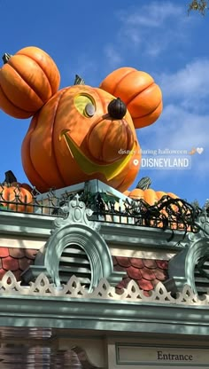 a mickey mouse pumpkin on top of a building