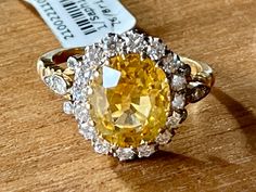 A bright yellow Sapphire is the central point of this classic Vintage Entourage Ring in 18 K yellow Gold. The yellow Sapphire has a weight of approximately 4.80 ct and is surrouded by 26 brilliant cut Diamonds weighing approximately 0.70 ct. The ring is currently size 55/15( US size 7 1/2) but can easily be resized. Masterfully handcrafted piece! Authenticity and money back is guaranteed. For any enquires, please contact the seller through the message center. Luxury Heirloom Yellow Sapphire Jewelry, 1st Dibs Jewelry, Canary Diamond Engagement Ring, Yellow Diamond Earring, Yellow Sapphire Ring, Canary Diamond, Yellow Sapphire Rings, Fancy Yellow Diamond, Diamond Earring