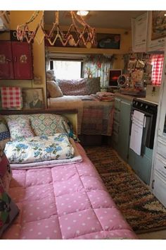 the inside of a camper with lots of furniture and decor on display in it