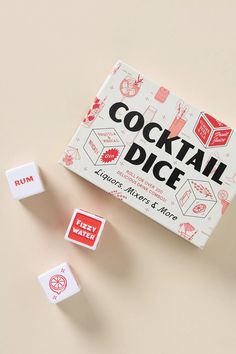 a box of cocktail dices next to two pieces of red and white cubes