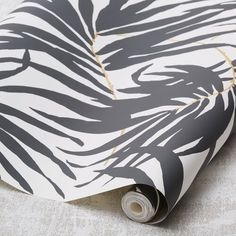 a black and white zebra print wallpaper with gold foiling on it's edges