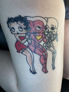 a woman's thigh with a skeleton and girl on it, in the shape of a heart