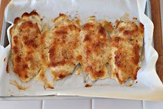 some food is laying out on a white tray and ready to be cooked in the oven