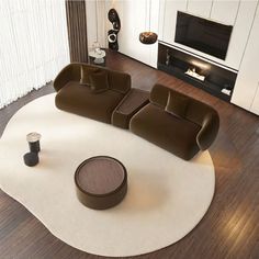 a living room filled with furniture on top of a white rug and hard wood flooring