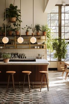 a kitchen with potted plants on the wall and bar stools in front of it