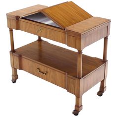 a wooden table with two drawers on one side and an open drawer on the other