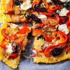 a close up of a pizza on a pan with many toppings and one slice missing