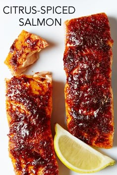 a close up of some food on a plate with a lemon wedge and the words citrus - spiced salmon